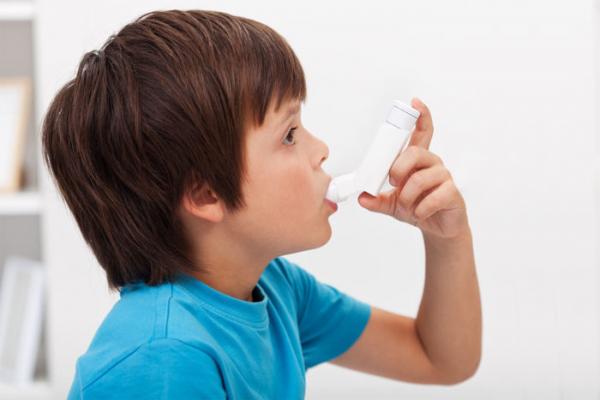Little boy using his inhaler
