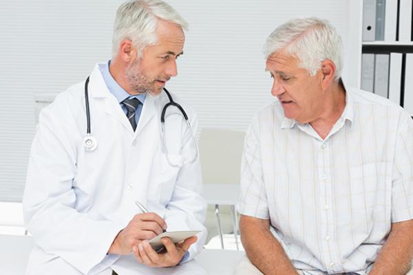 Doctor discussing something in a room with patient
